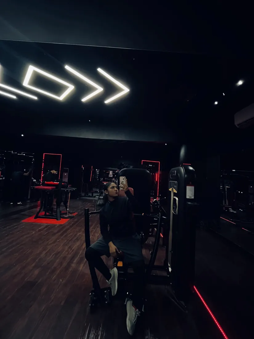 Smartinn Fitness gym floor at night under the neon chevron lights