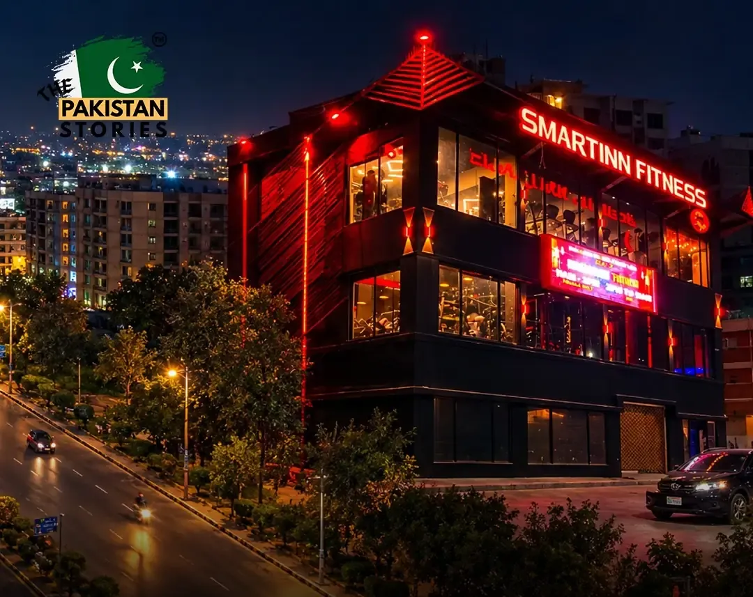The Smartinn Fitness building lit red at night on Shahrah-e-Faisal